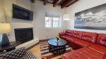 Comfortable living room with red leather sofa that seats five